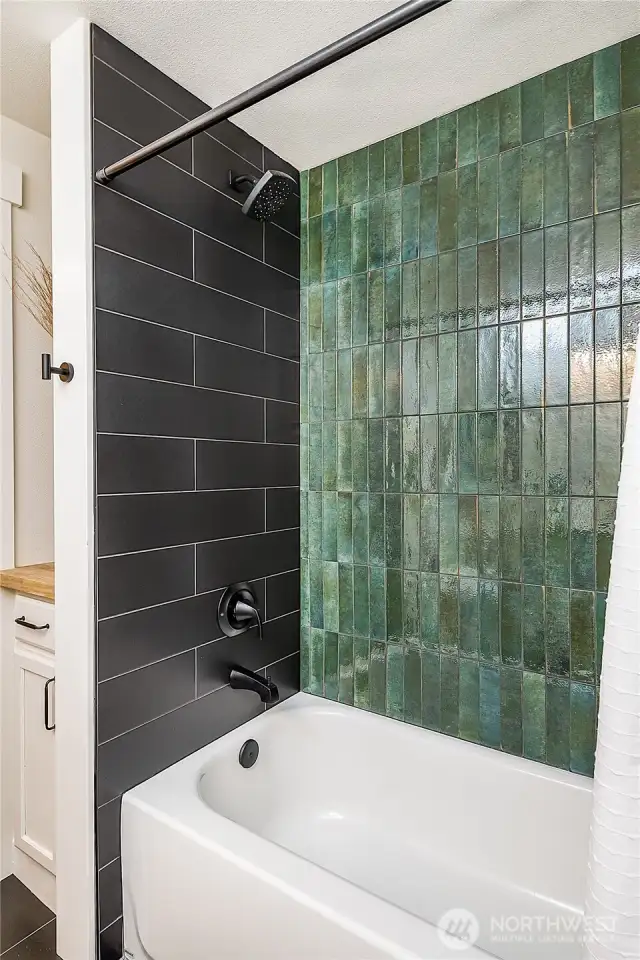 A full bath with a tub is ideally situated off the living room and kitchen, offering easy access for guests and family alike