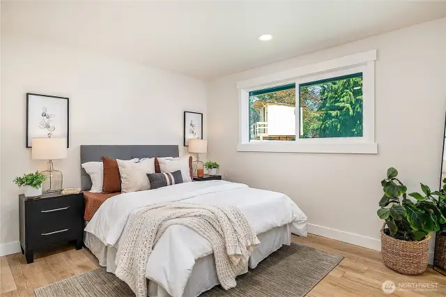 The spacious primary bedroom is a peaceful retreat, featuring ample natural light and a serene ambiance