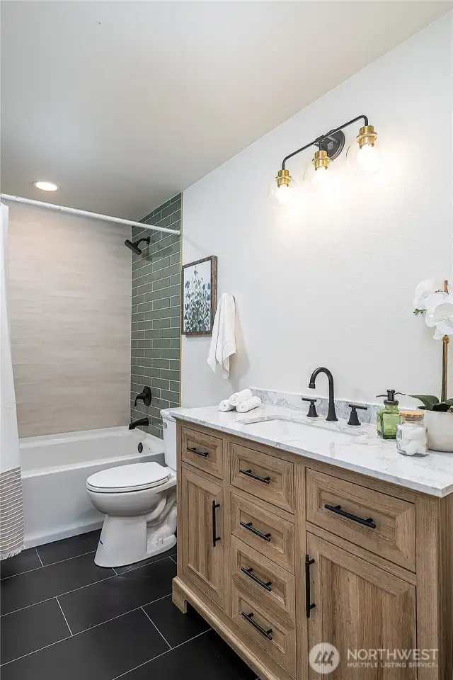 A beautifully designed full hall bath provides comfort and functionality for both residents and guests