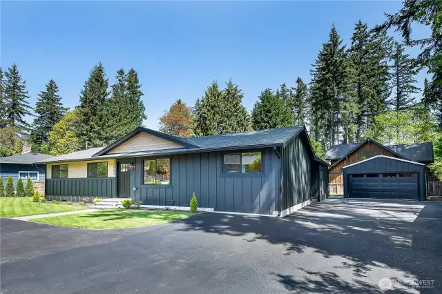 A spacious detached garage or shop offers ample room for vehicles, hobbies, or storage, providing both functionality and flexibility