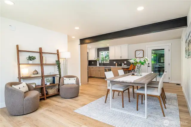 A spacious entryway with a charming seating area sets the tone for the home, flowing gracefully into the dining room for effortless entertaining