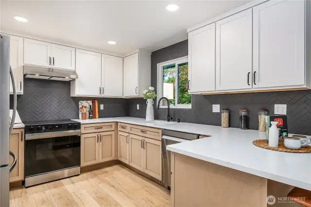 The kitchen boasts custom cabinetry and all-new appliances, offering both style and functionality for the home chef.