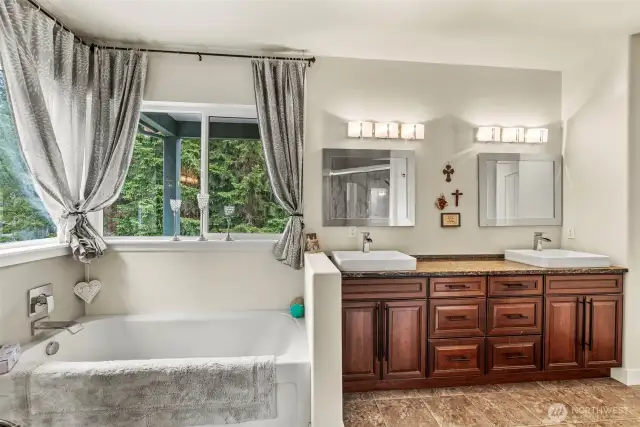 Primary bathroom with beautiful views of the outside as you relax