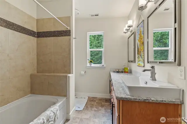 Guest bathroom with extra deep soaking tub, plumbed for second sink with quartz counters