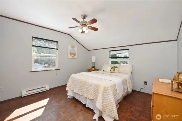 One of the upstairs bedrooms, note the many ceiling fans throughout