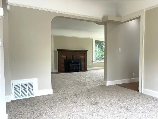 Standing in the dining room area and looking towards the living room area. The kitchen doorway is to the right. You can see the furnace air return here. There is a brand new American Standard furnace installed in the basement.