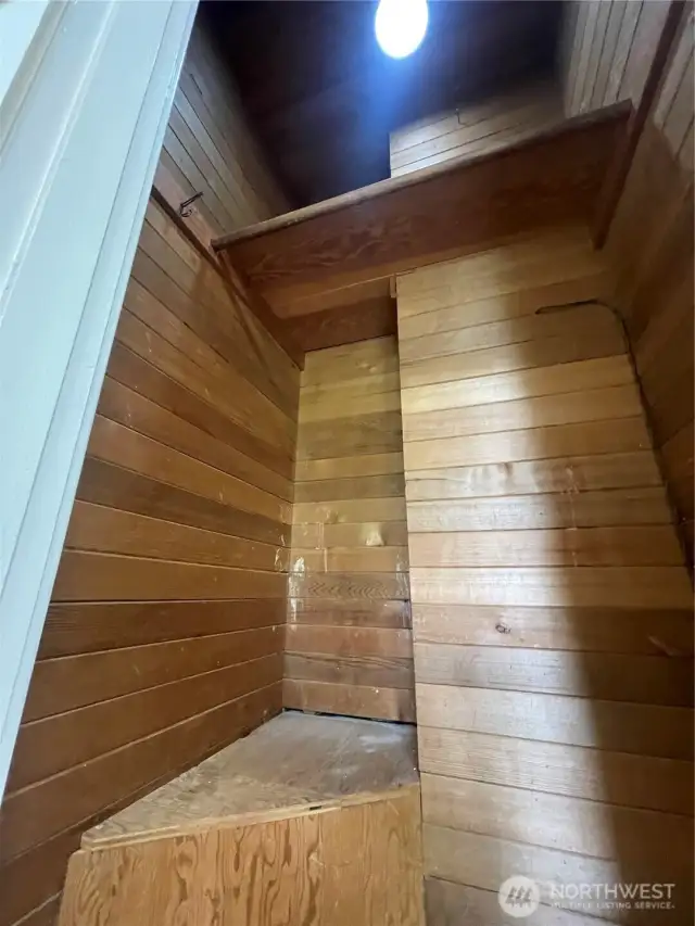 Each bedroom features a cedar lined closet. This is in bedroom number 2 and features a little seat and a shelf. They don't make them like this anymore! No need to worry about moths eating your wool clothing! Motion sensor lighting is installed.