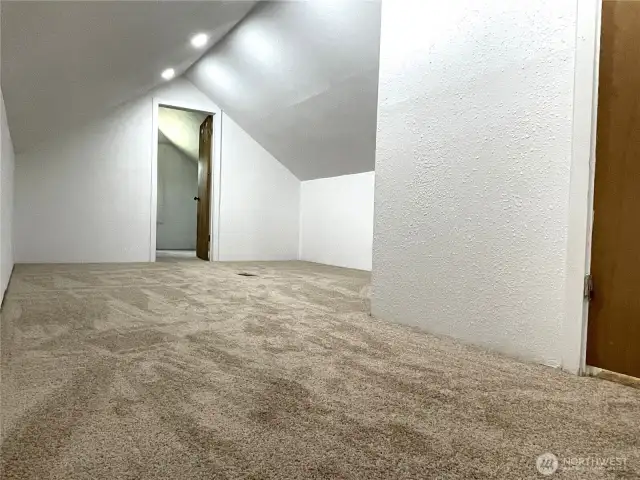 The upper area features an open area, shown here, and two additional rooms. One has a closet so it is being counted as a fourth bedroom.