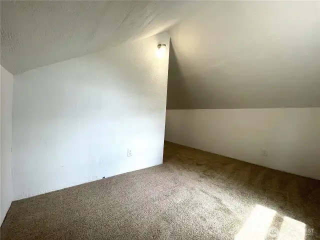 The upper fourth bedroom features new carpet and lighting and is freshly painted.