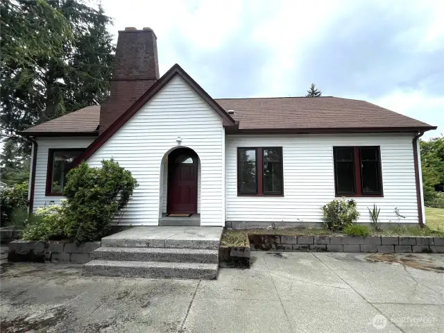 Another view of the front of the house, showing the importance of the chimney and the gabled front sloped entry. Very unique and of the English style. Built in 1931, could have been a Sears Kit home.