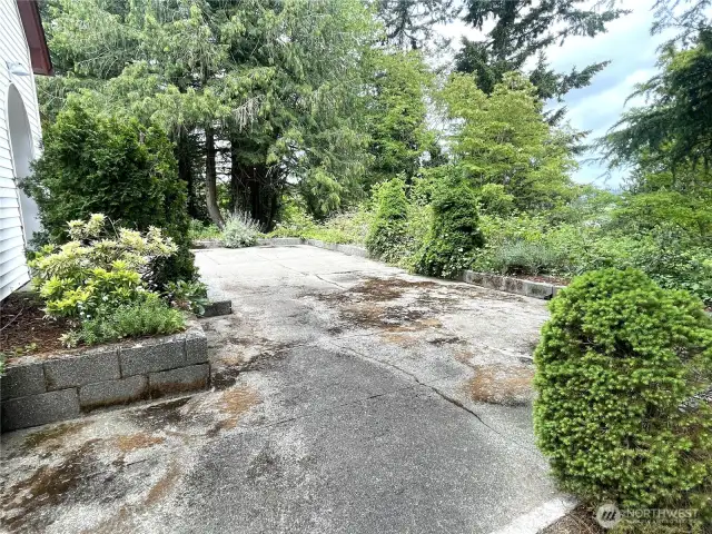 Lots more poured concrete in front of the house.  This area is enclosed by so many raised garden areas. The potential is enormous. Just needs a little TLC.