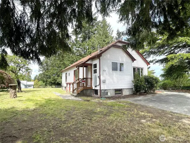 From the road and looking towards the house, you can see the back entry and the expansive side yard.