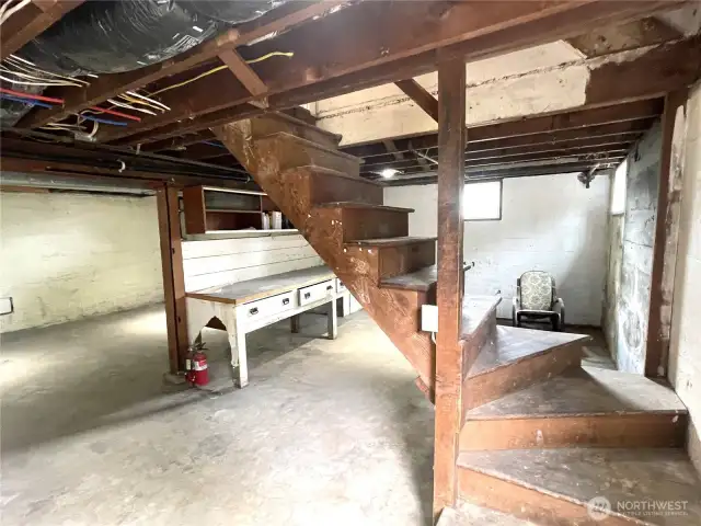 A full basement with interior access shown here. Note the updated pex type water lines in the ceiling. A built in work bench with drawers that are thicker than you can believe will be ready to be your solid work station.