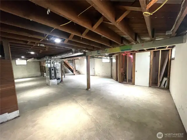 Lots of potential here. The door shown here opens to the potential bathroom. It is plumbed and even has an electric flush pump already installed. You can see the brand new furnace in the middle of the room here.