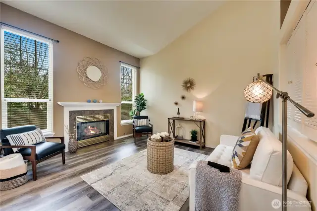 Spacious living room with cozy gas fireplace and lots of natural light