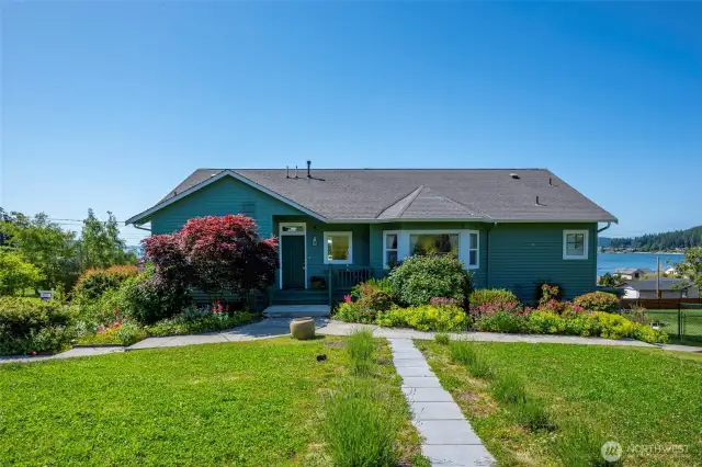 Enter through the garden gate & follow the stepping stones to the front door. Enjoy the beautiful landscaping along the way!