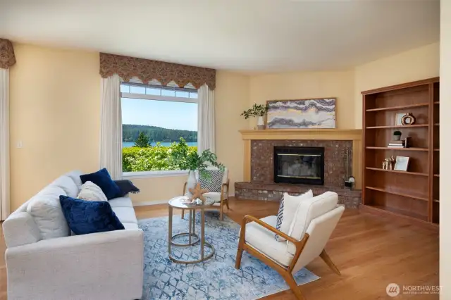 Large living room with a wood burning fireplace to relax & enjoy the water views!