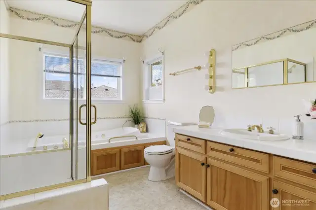 Primary bathroom offers a huge jacuzzi soaking tub & separate tiled shower.