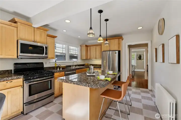 Spacious sunny kitchen with pendant lights and granite countertops