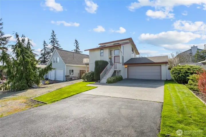 Large and useable front yard with attached garage and additional parking options.