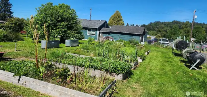 Raised container beds and composting bins convey with purchase