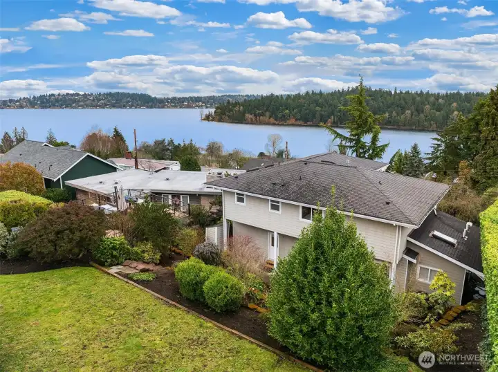 Lawn at the top of the tiered lot.  With views of water.