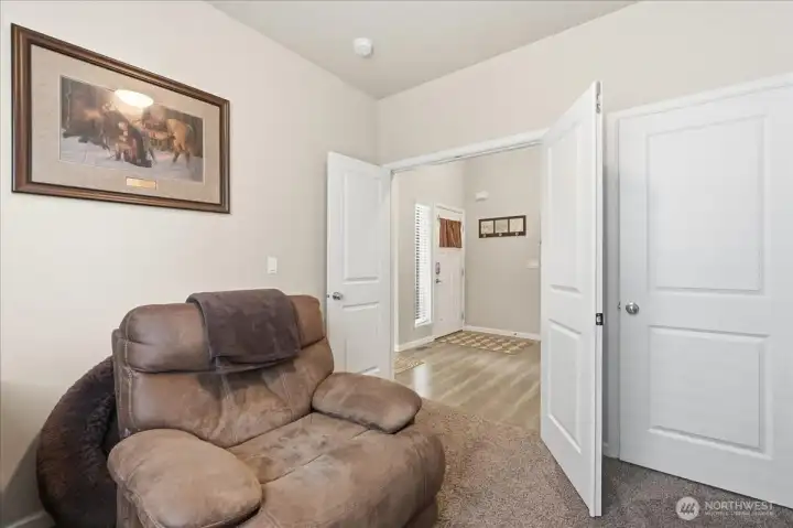 TV room has double door just off the entry-way