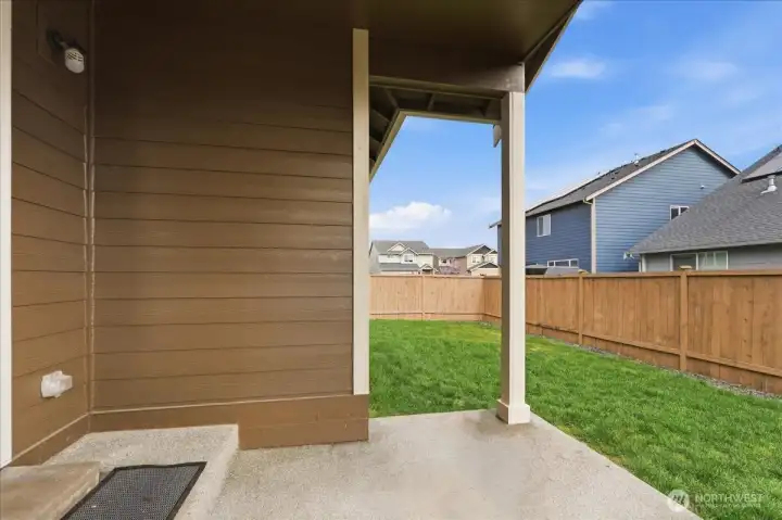 Fully fenced back yard with side gate.