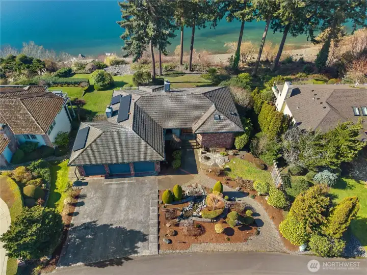 Aerial perspective highlights the home’s exceptional lot and water view setting.