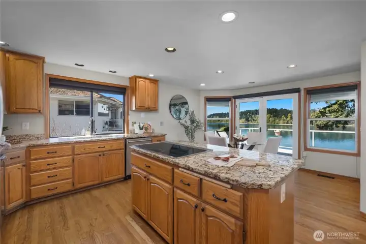 Kitchen and dining area connect beautifully to the deck and water views beyond.