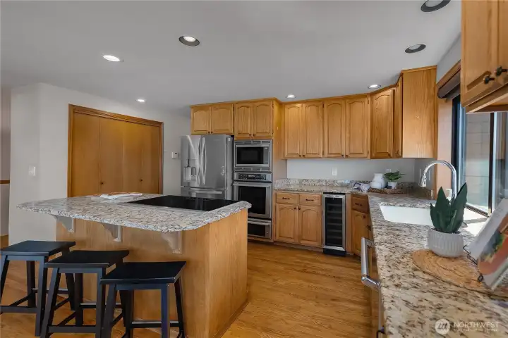 Granite counters, center island, and ample cabinetry make this kitchen a standout.