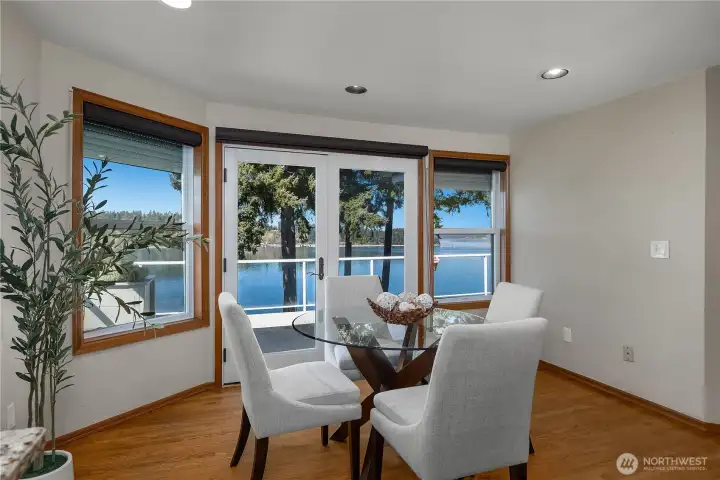 Bright breakfast space captures the view and offers deck access just beyond.
