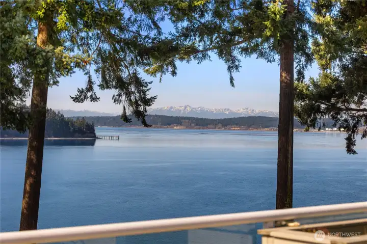 Panoramic outlook captures sparkling water and stunning  Olympic Mountain vistas.