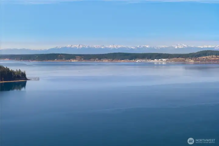 Iconic Northwest scenery with open water, shoreline, and Olympic Mountain views.