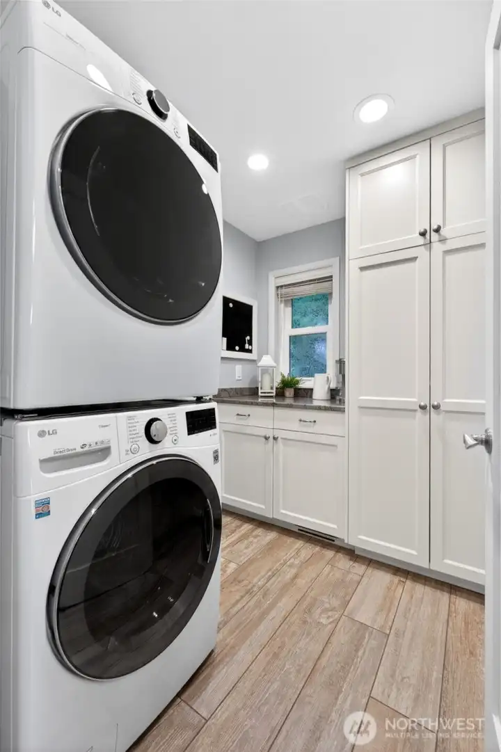 The conveniently located laundry room is just off the entry and includes both washer and dryer.