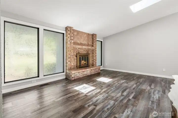 Large living room with vaulted ceilings and fireplace.