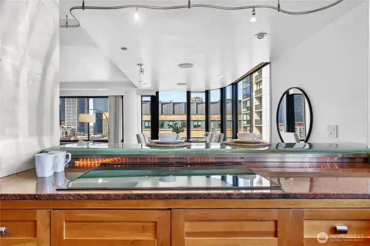 Glass bar top with granite counters. The kitchen views the dining and living room area.