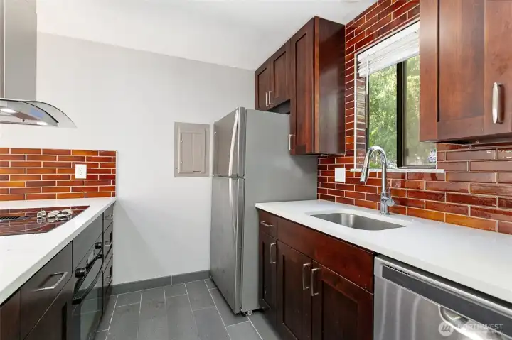Kitchen with tile floor and quartz tops