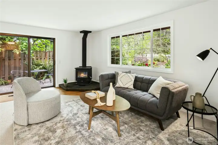 The cozy wood burning stove and sliding door out to the patio compliment the spacious living room. The cozy wood burning stove and sliding door out to the patio compliment the spacious living room.