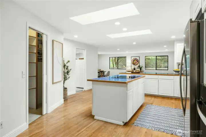 The large kitchen features a deep pantry, island with cooktop, and sit-up bar. The large kitchen features a deep pantry, island with cooktop, and sit-up bar.