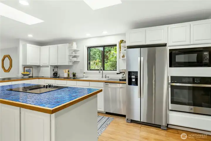 Skylights bring warmth and sun into the open kitchen. Skylights bring warmth and sun into the open kitchen.