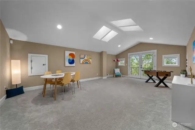 The surprise bonus room on the third level offers additional space for everyone, perfect for a playroom or a spacious home office. Skylights provide ample natural light, creating a bright and inviting atmosphere.