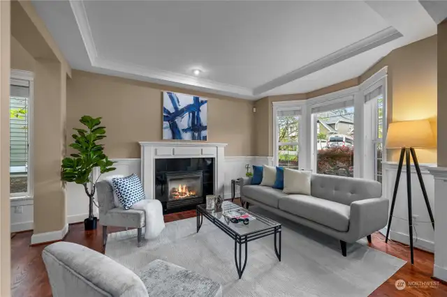 Experience sophistication and warmth in this formal living area, complete with crown molding and a fireplace, creating the perfect ambiance for holiday gatherings or any special occasion.