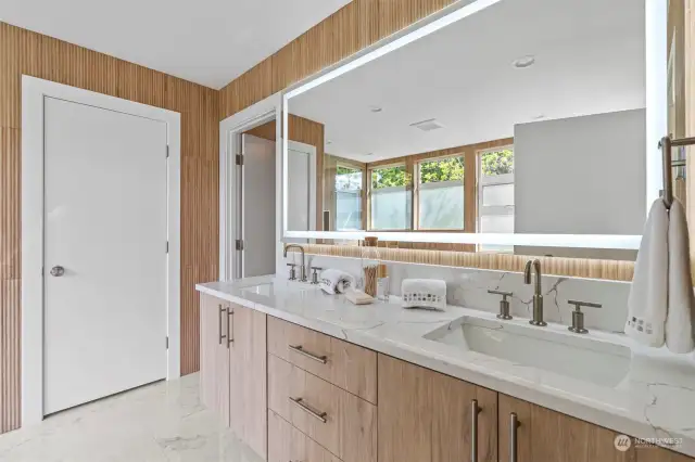 Lite mirrors, Quartz counter tops, custom cabinets and heated floors.