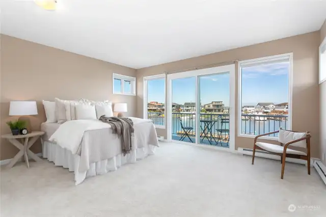 The primary bedroom has a balcony and beautiful water and Mount Baker views