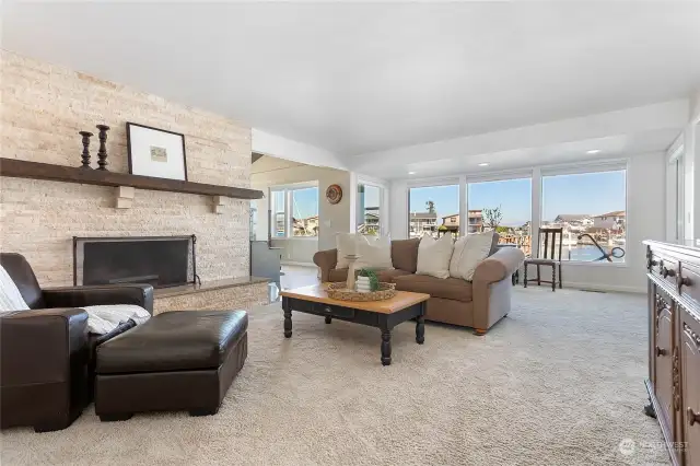 The serene living room with a fireplace and water views