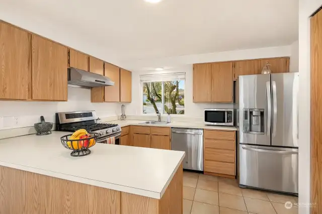 Sparkling open Kitchen With Newer Stainless Appliances, Plenty of Storage and Counter Space. Gas Line Extended From the Garage, to Accommodate New Gas Range/ All Kitchen Appliances Stay, Including Microwave; This Space is Just Waiting for Your Personal Touches