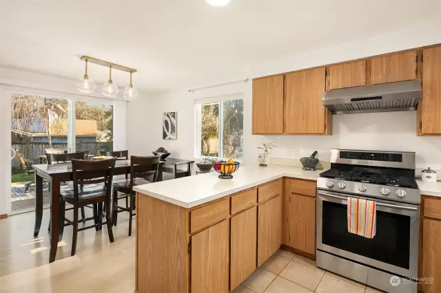 Open Concept Kitchen Adjacent to the Dining Room With Sliding Glass Doors to Large Deck and Yard