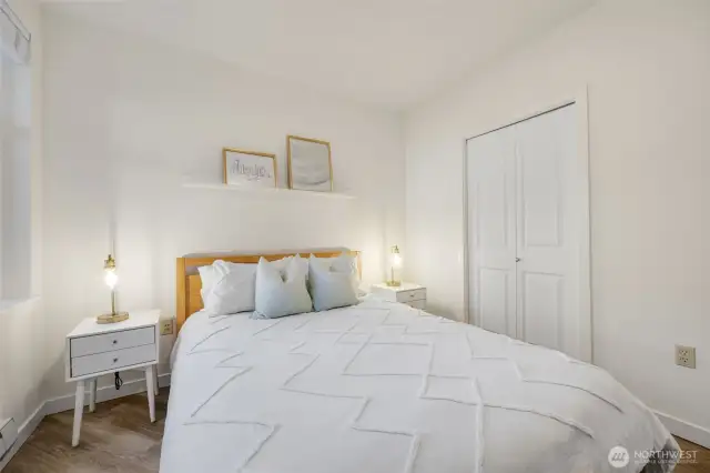 The tranquil bedroom features a walk-in closet with custom shelves and an electronic wall safe.