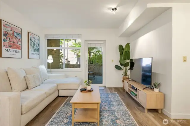 The open layout flows seamlessly to a spacious, landscaped patio.